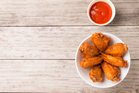 plate of chicken wings on wooden tableの写真素材