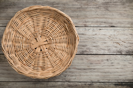 threshing basket on rustic wooden background top viewの写真素材