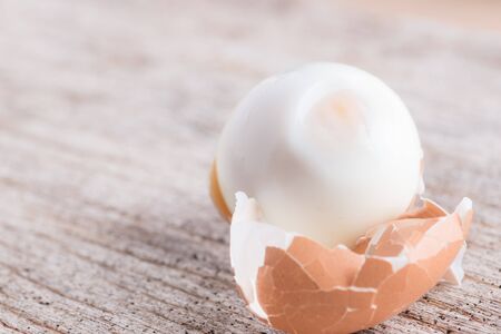 Peeled boiled egg on wooden backgroundの写真素材