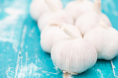 Garlic on green wooden backgroundの写真素材