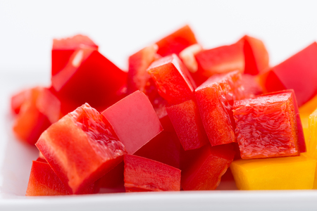 Diced Red, Green & Yellow Pepper together in white plate close upの写真素材
