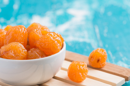 Preserved fruits or dried honey Chinese plum on rustic green wooden backgroundの写真素材