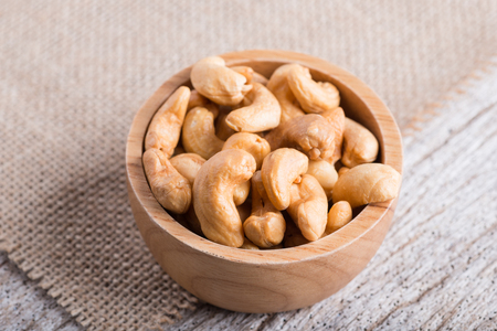 Roasted cashew nuts on rustic wood table backgroundの写真素材