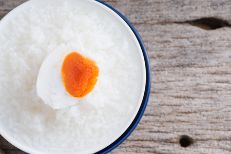 Rice gruel, boiled rice or rice congeeand with salted egg, chinese food styleの写真素材