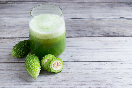 Herbal juice of green momodica , Balsam apple, Balsam pear, Bitter cucumber , Bitter gourd , Stuffed bitter gourd, karela in a glass with sliced vegetables, karela juice or bitter gourd juiceの写真素材