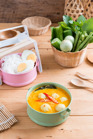 Coconut milk Curry fish and fish ball eat with thai rice noodle ( Kanom jeen nam ya ) , boiled egg and vegetableの写真素材