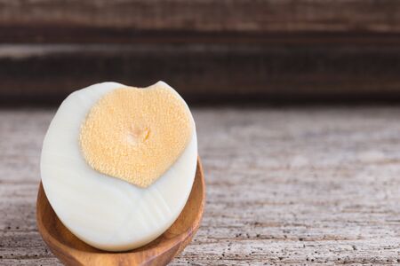 Peeled boiled egg on wooden backgroundの写真素材