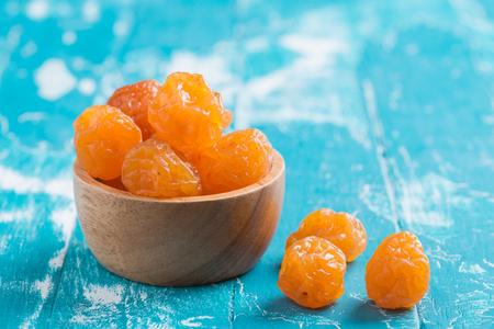 Preserved fruits or dried honey Chinese plum on rustic green wooden backgroundの写真素材