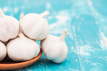 Garlic on green wooden background