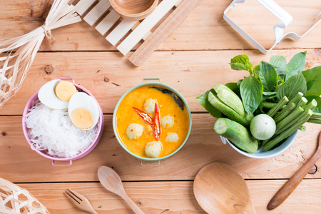 Coconut milk Curry fish and fish ball eat with thai rice noodle ( Kanom jeen nam ya ) , boiled egg and vegetableの写真素材