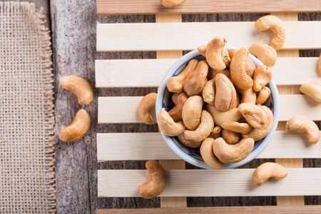 Roasted cashew nuts on rustic wood table backgroundの写真素材
