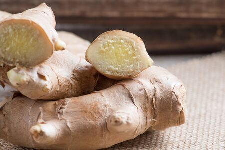 Organic ginger on a rustic wooden board backgroundの写真素材