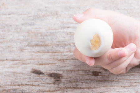 Peeled boiled egg on wooden backgroundの写真素材