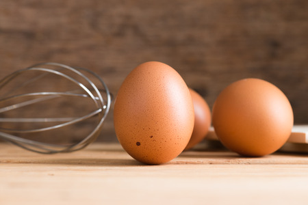 Organic eggs on wooden background.