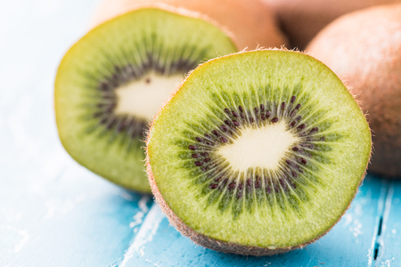 Kiwi fruit in a bowl on wooden background.の写真素材