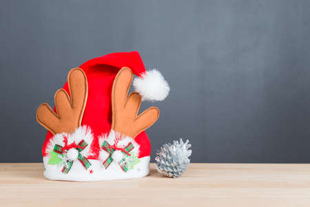 Santa hat on wooden table with copy spaceの写真素材
