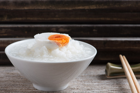 Rice gruel, boiled rice or rice congeeand with salted egg, chinese food styleの写真素材