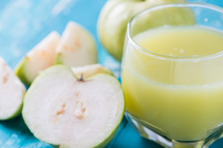Guava juice and fresh Guava on wooden backgroundの写真素材