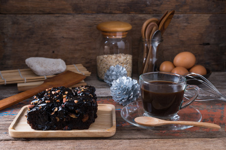 Chocolate brownie with almond topping over wooden backgroundの写真素材