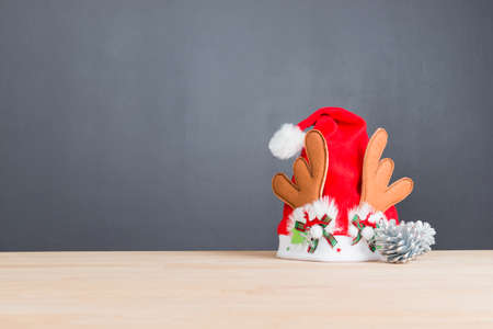 Santa hat on wooden table with copy spaceの写真素材