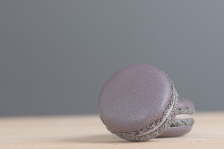 Colorful macaroons. Sweet macarons on retro  background with copy space. Vintage filter.の写真素材