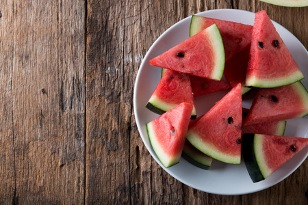 Red Watermelon on wooden table backgroundの写真素材