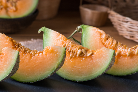 Melon slice on wooden table backgroundの写真素材