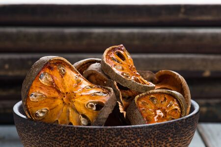 Dry Bael fruit - Slices of dry Bael fruit on the  white wooden table backgroundの写真素材