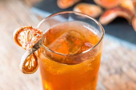Bael juice ice tea on wooden table background , healthy drinkの写真素材