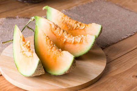 Melon slice on wooden table backgroundの写真素材