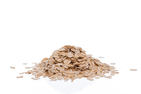 Oat flakes isolated on white backgroundの写真素材