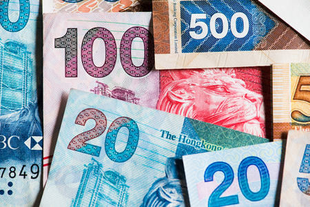 Pile of many Hong Kong Dollar banknotes as money background.