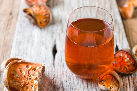 Bael juice on wooden table background , healthy drink