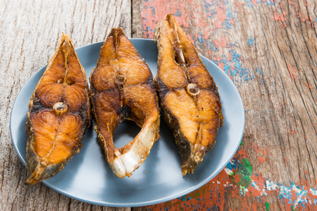 Deep fried fish on wooden table backgroundの写真素材