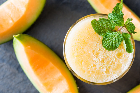 The juice of melon with mint in a glass  on the table.Hami melonの写真素材