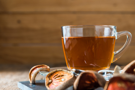 Bael tea juice on wooden table background , healthy drinkの写真素材