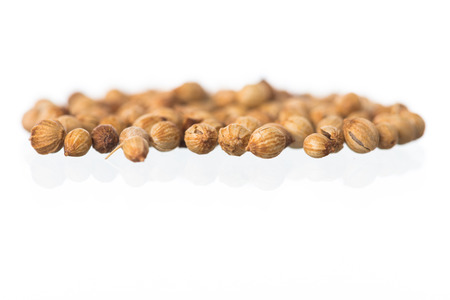 Pile of coriander seeds isolated on white backgroundの写真素材