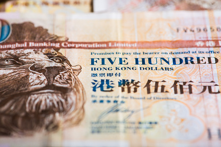 Pile of many Hong Kong Dollar banknotes as money background.
