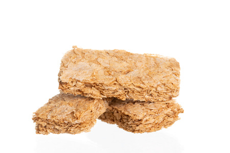 Whole grain wheat biscuits breakfast cereal isolated on white background
