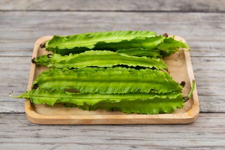 Psophocarpus tetragonolobus, Winged Bean on wooden table