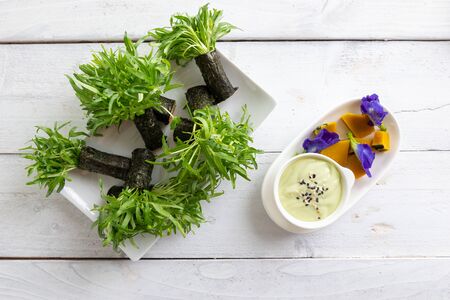 fresh vegetable in sea weed roll in plated on wood background