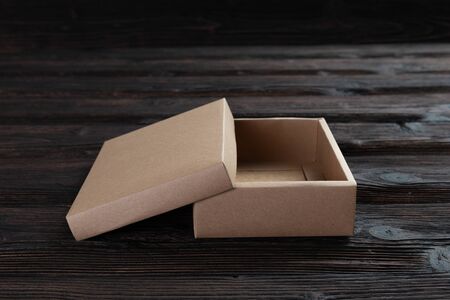 Cardboard box on a dark rustic wooden background