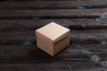 Cardboard box on a dark rustic wooden background