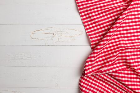Red towel over wooden kitchen table. View from above with copy space
