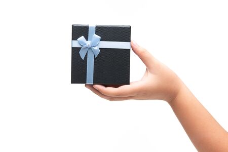 Girl Hand Hold Gift box with blue ribbon isoalted on white background.の写真素材