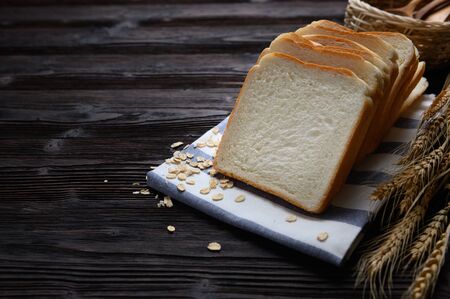 Fresh homemade  baked bread and sliced bread on wooden table