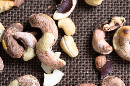Roasted shelled cashews on natural wooden table background