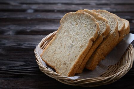 Fresh homemade  baked whole grain bread and sliced bread on wooden tableの写真素材