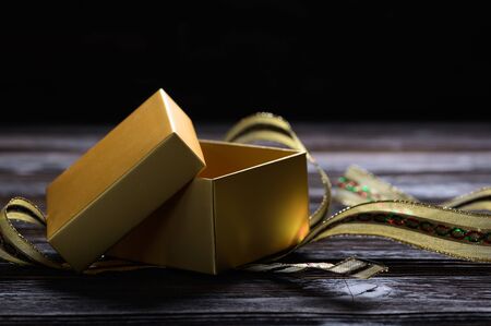 Christmas background with open gold paper gift boxes and decorationsの写真素材