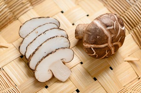 Shiitake mushrooms (Lentinus edodes) on the wooden background.の写真素材